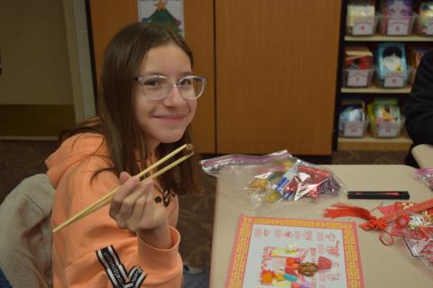 5th graders learning to use chopsticks