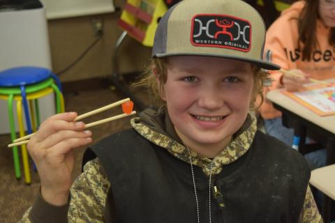 5th graders learning to use chopsticks